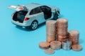 Auto loan: interest rates, car with open boot, blue background