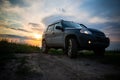 SUV with big wheels at sunset