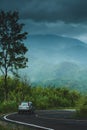 SUV car driving on the curve mountain road