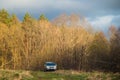 suv car in early spring forest Royalty Free Stock Photo