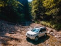 suv car mountains creek on background Royalty Free Stock Photo