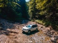 suv car mountains creek on background Royalty Free Stock Photo