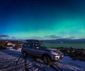 SUV car in the parking place under northen lights in Atlantic Ocean Road Royalty Free Stock Photo