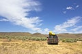 SUV Car With Yellow Kayaks In Desert