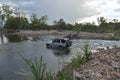SUV or Four by Four crossing a river