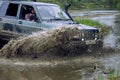 4x4 off-road car crosses a water barrier with splashes at high speed. Royalty Free Stock Photo