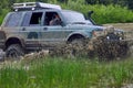 SUV or off-road vehicle crosses a river with splashes of dirty water. Royalty Free Stock Photo