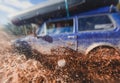 Suv offroad 4wd car rides through muddy puddle, off-road track road, with a big splash, during a jeeping competition Royalty Free Stock Photo