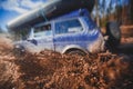 Suv offroad 4wd car rides through muddy puddle, off-road track road, with a big splash, during a jeeping competition Royalty Free Stock Photo