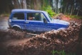 Suv offroad 4wd car rides through muddy puddle, off-road track road, with a big splash, during a jeeping competition Royalty Free Stock Photo