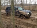 Suv offroad 4wd car rides through muddy puddle Royalty Free Stock Photo