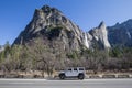 SUV on roadway in front of Bridal Veil Falls in Yosemite National Park