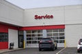 An SUV is seen in front of doors leading to the service department of an automobile dealership