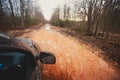 Suv 4wd car rides through muddy puddle, off-road track road, with a big splash, during a jeeping competition Royalty Free Stock Photo