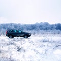 SUV in winter countryside