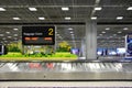 Suvarnabhumi Airport, Bangkok, Thailand - March 1, 2018 : empty metal conveyor belt with baggage claim sign in arrival hall area Royalty Free Stock Photo