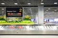 Suvarnabhumi Airport, Bangkok, Thailand - March 1, 2018 : empty metal conveyor belt with baggage claim sign in arrival hall area