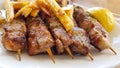 Suvlaki or suvlakia with potatoes on the plate in greece Royalty Free Stock Photo