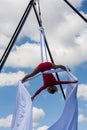 Athletic Woman Demonstrates Aerial Gymnastics With Silks At Fall Festival