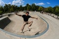 Man Performs Midair Trick In Bowl At Skateboard Park Royalty Free Stock Photo