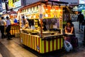 Suwon, South Korea - June 14, 2017: Adult woman enjoying fast food at the main street in Suwon