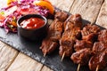 suya kebab with Spicy Peanut Spice Blend served with fresh vegetable salad and ketchup close-up. horizontal