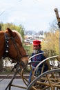 Suzdal, Russia - April 25, 2023. A man in the historic outfit of a coachman stands near a horse and a carriage Royalty Free Stock Photo