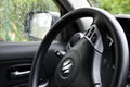 Logo Suzuki at car driver steering wheel closeup