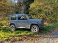 Suzuki Jimmy, small jeep parked in a forested area