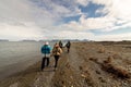 Svalbard, Norway, August 3, 2017: Group of tourists walking at the beach at Prins Karls Forland at Svalbard, looking for