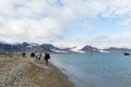 Svalbard, Norway, August 3, 2017: Tourists on the island Prins Karls Forland is walking towards pick up place, where the