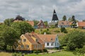 View of village of Svaneke in Denmark and modern three-legged water tower designed by Jorn Utzonon