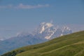 Svaneti - Hill landscape with panoramic view on high mountains in Greater Caucasus Mountain Range in Georgia. Royalty Free Stock Photo