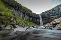 Svartifoss waterfall in skaftafell region on iceland. Beautiful waterfall viewed from low view, a lot of water coming from Royalty Free Stock Photo