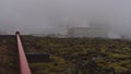 Svartsengi Power Station near Grindavik, Reykjanes, Iceland with moss covered lava field in front and red colored pipeline. Royalty Free Stock Photo