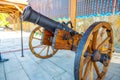 vintage bombing cannon artillery gun for shooting on the embankment of the city on a summer sunny day