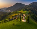 Sveti Andrej, Slovenia - Aerial drone view of Saint Andrew church Sv. Andrej at sunset in Skofja Loka area