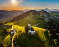 Sveti Andrej, Slovenia - Aerial drone view of Saint Andrew church Sv. Andrej at sunset in Skofja Loka area