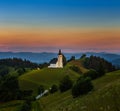 Sveti Andrej, Slovenia - Saint Andrew church Sv. Andrej at sunset in Skofja Loka area with Julian Alps and colorful sky