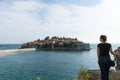 Sveti Stefan in Budva Montenegro Young girl traveler. Adriatic sea with boats and an old small town in a island. Stone luxury Royalty Free Stock Photo