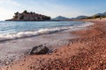 Sveti Stefan - Tranquil waves at paradise sand beach with scenic view of idyllic island Sveti Stefan, Budva Riviera, Montenegro Royalty Free Stock Photo