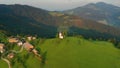 Sveti Tomaz, Slovenia - 4K aerial footage about drone flying away Saint Tomas Sveti Tomaz Church at Skofja Loka