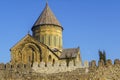 Svetitskhoveli Cathedral, Mtskheta, Georgia. The dome of the Cathedral above the battlements against the blue sky. Royalty Free Stock Photo