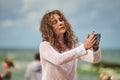 Female dance performance on sunny beach, sea waves background, woman dancer dancing outdoor