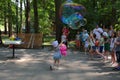 Svetlogorsk, Russia - June 08, 2019: Magician entertains tourists with bubbles in city park Royalty Free Stock Photo