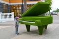SVETLOGORSK, RUSSIA. The little boy stands near a topiarny sculpture Grand piano