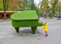 SVETLOGORSK, RUSSIA. A little boy holds onto the topical sculpture `Royal.` Kaliningrad region