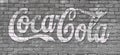 Svetlovodsk, Ukraine - 02.2021: Stylized Coca Cola lettering on a textured brick wall, editorial.