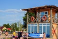 Svityaz- September 2019: Lifeguard tower for rescue baywatch on beach. Wooden house on sea shore on cloudy sky background. Summer