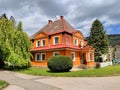 Beautiful Art Nouveau villa with orange facade and tidy green garden around it